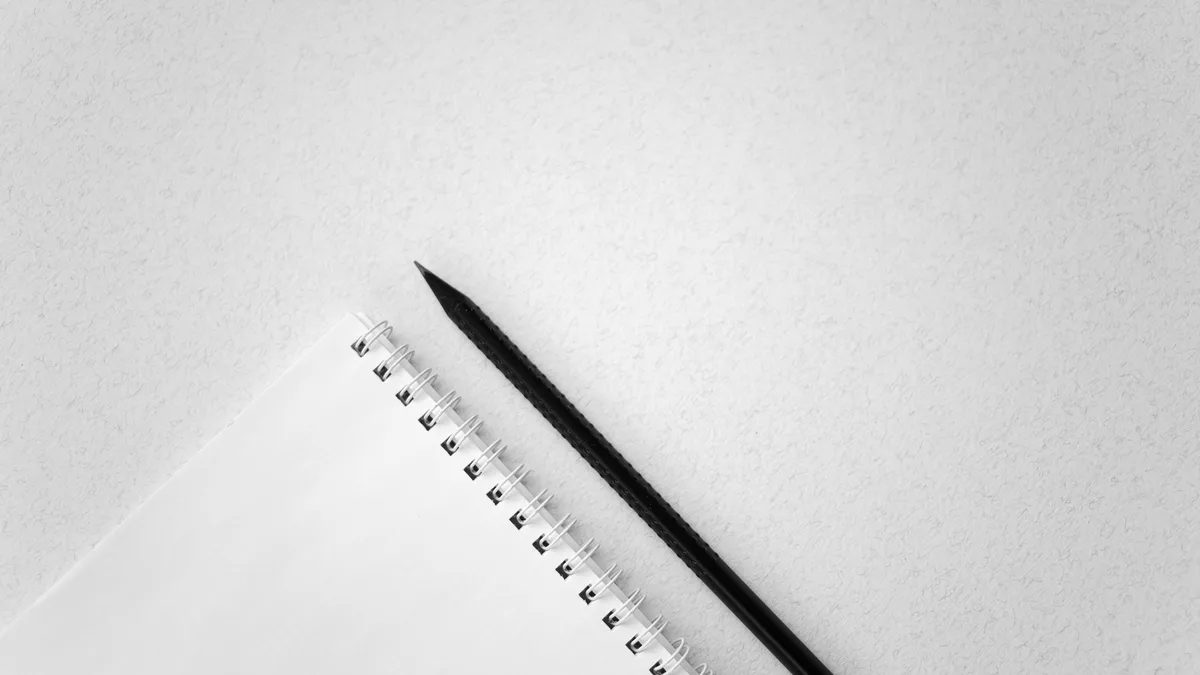 A pencil beside a spiral notebook, representing a clear GoHighLevel affiliate program disclosure