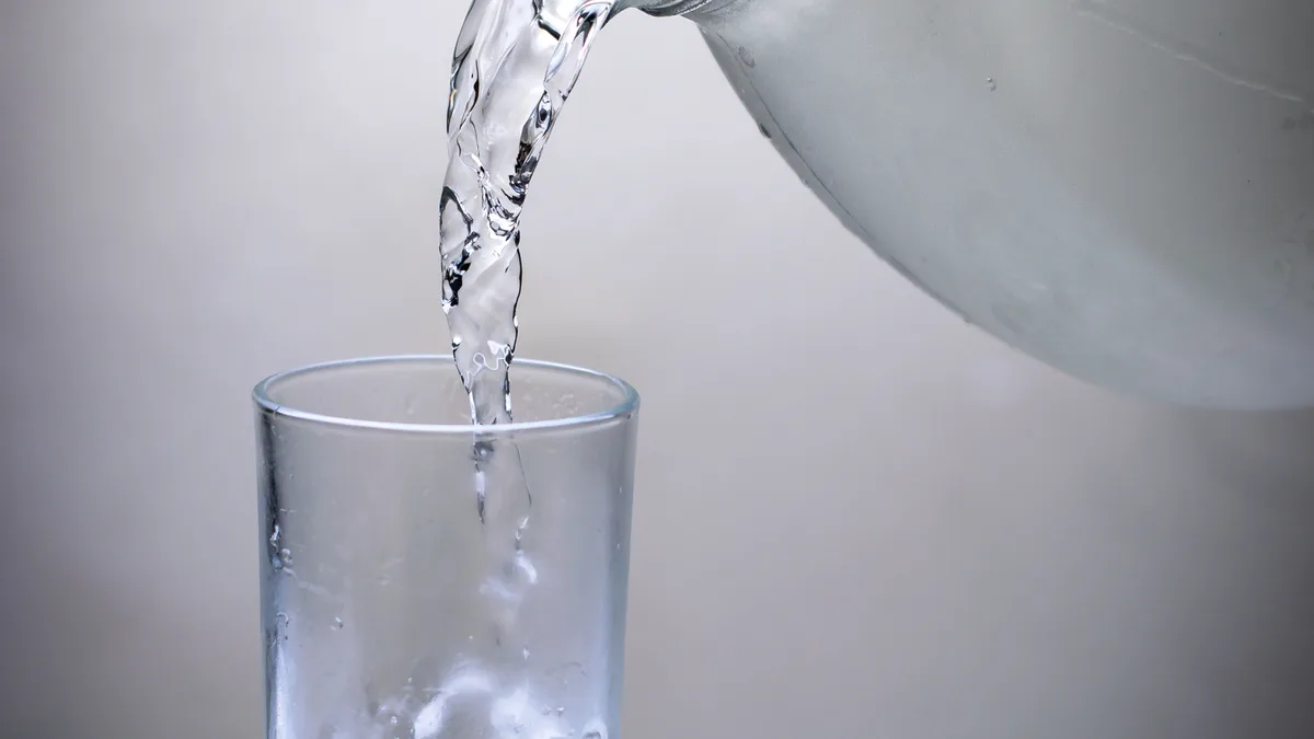 Water pouring into a glass, representing the recurring commission in the GoHighLevel affiliate program
