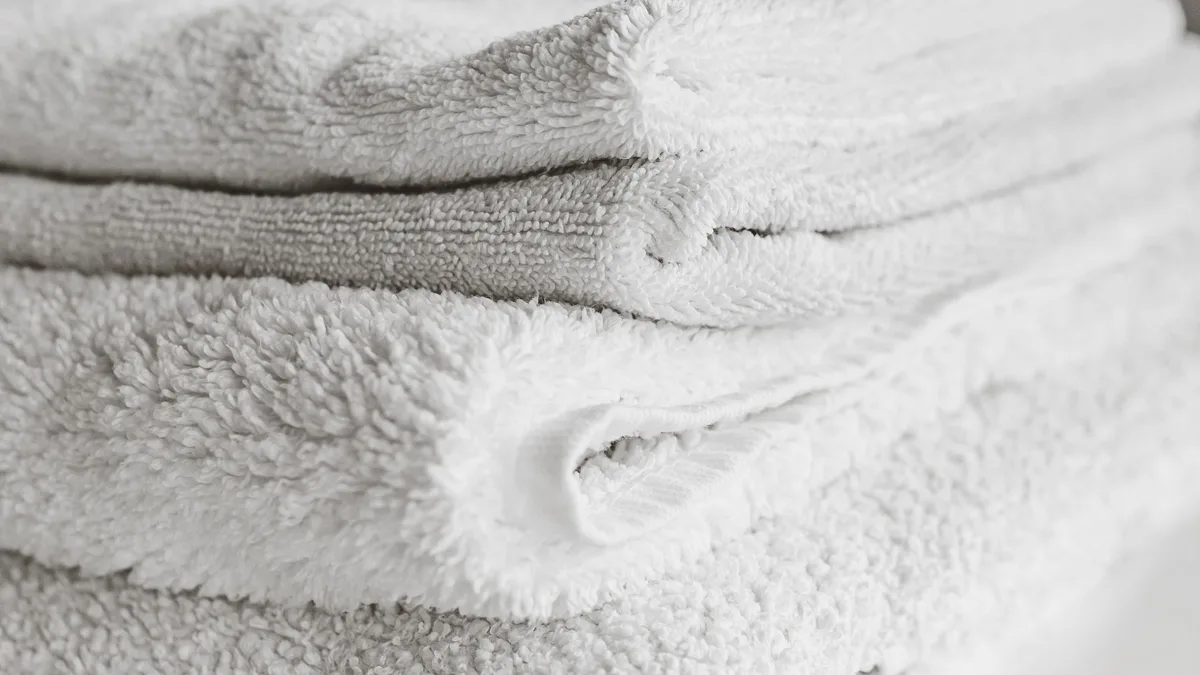 A neat stack of folded towels, representing an organized handoff to GoHighLevel for gyms