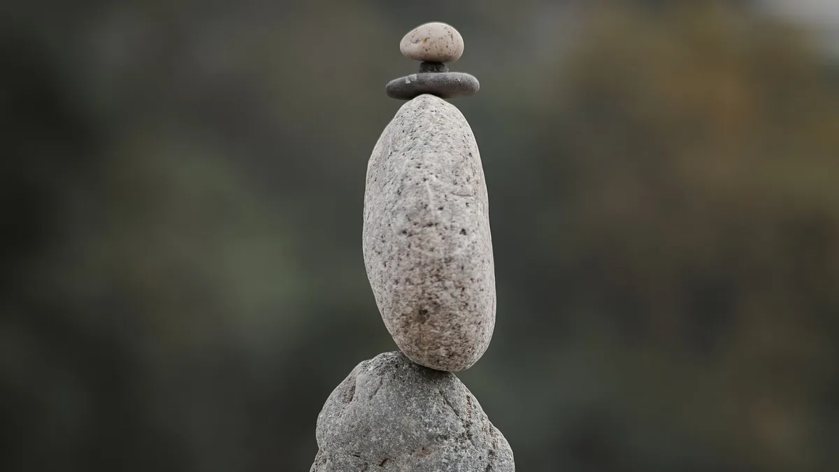 Smooth stones balanced in a stack, representing usage costs on top of GoHighLevel plans