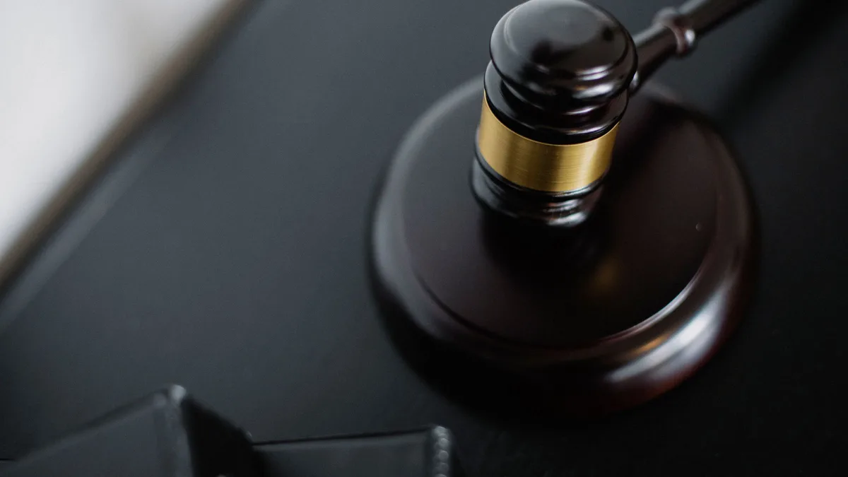 A wooden gavel resting on its block, representing the public rules behind phone number porting