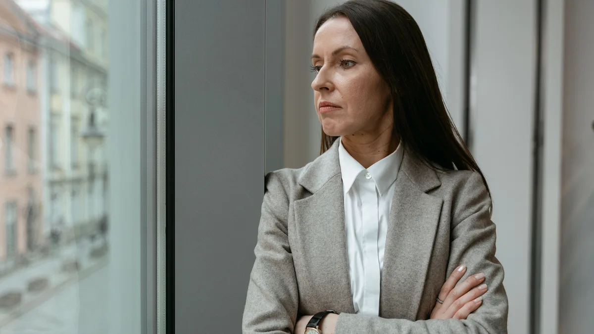 A business owner standing by a window, introducing common questions about white label CRM accounts