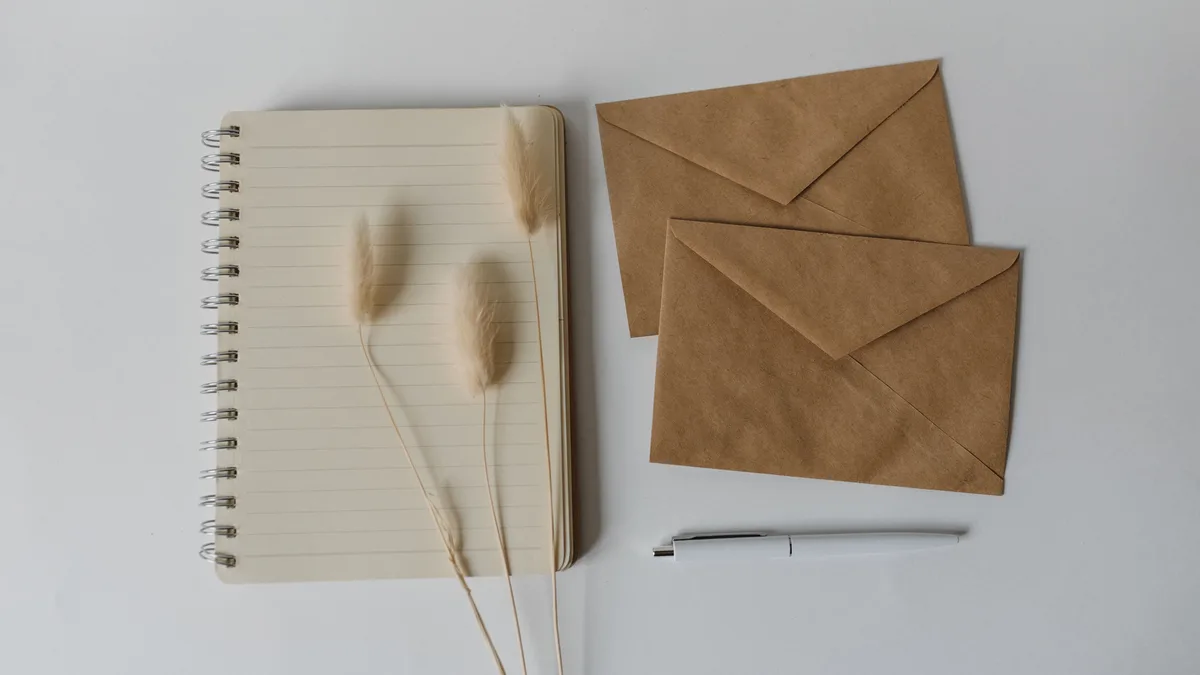 A blank notebook and envelope, representing a vague line item on a white label CRM invoice
