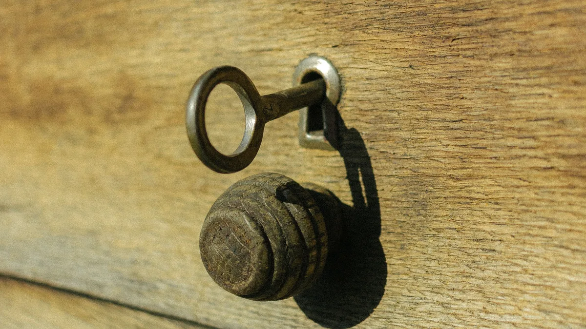 A key in a door lock, representing the login web address of a white label CRM