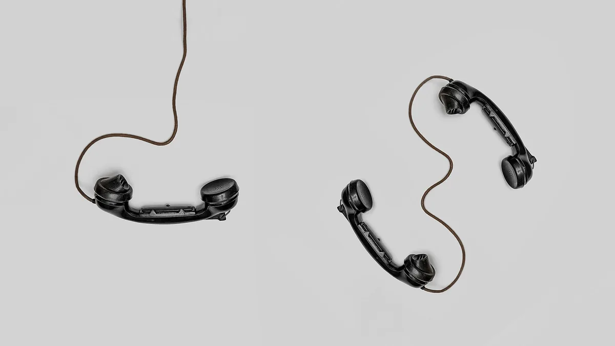 Two phone handsets on cords, representing the phone provider behind a white label CRM