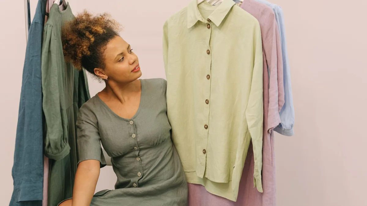 A boutique owner beside a rack of clothes, from our GHL contact first name guide