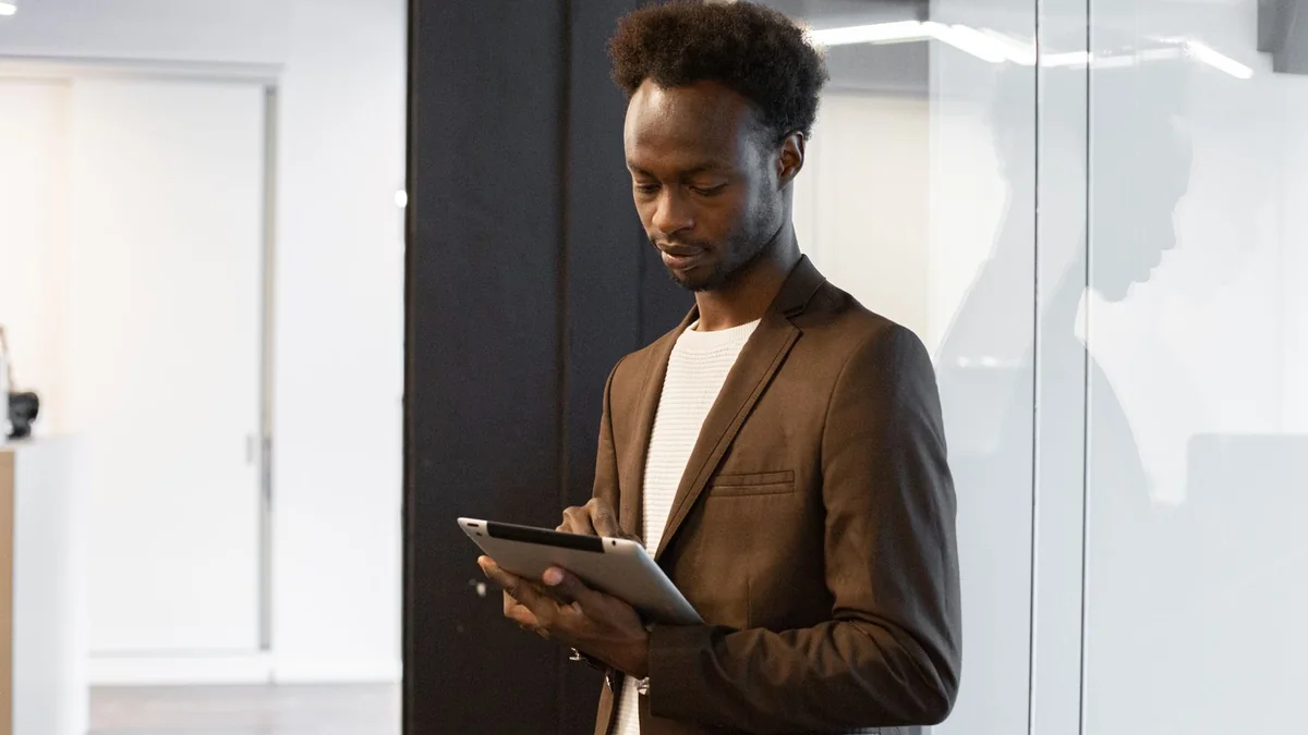 A consultant reviews a checklist on a tablet, from our GHL maintenance retainer guide
