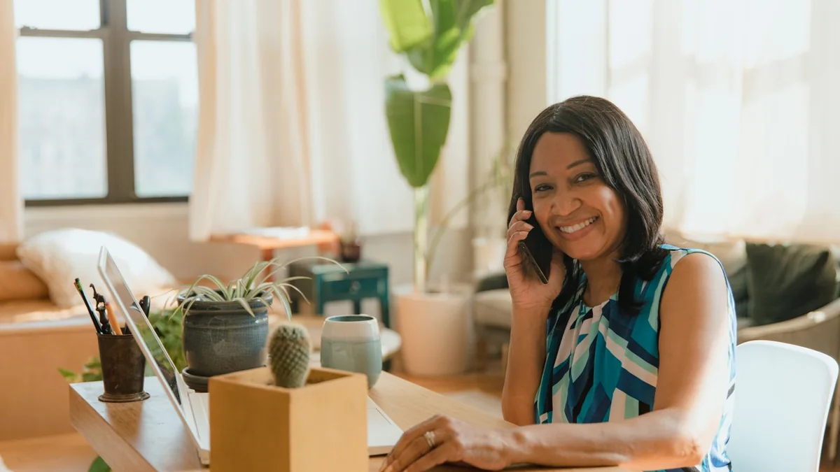 An office manager on a call at her desk, from our GHL sign up guide