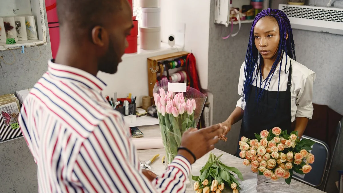 A florist serves a customer at her counter, from our GoHighLevel billing guide