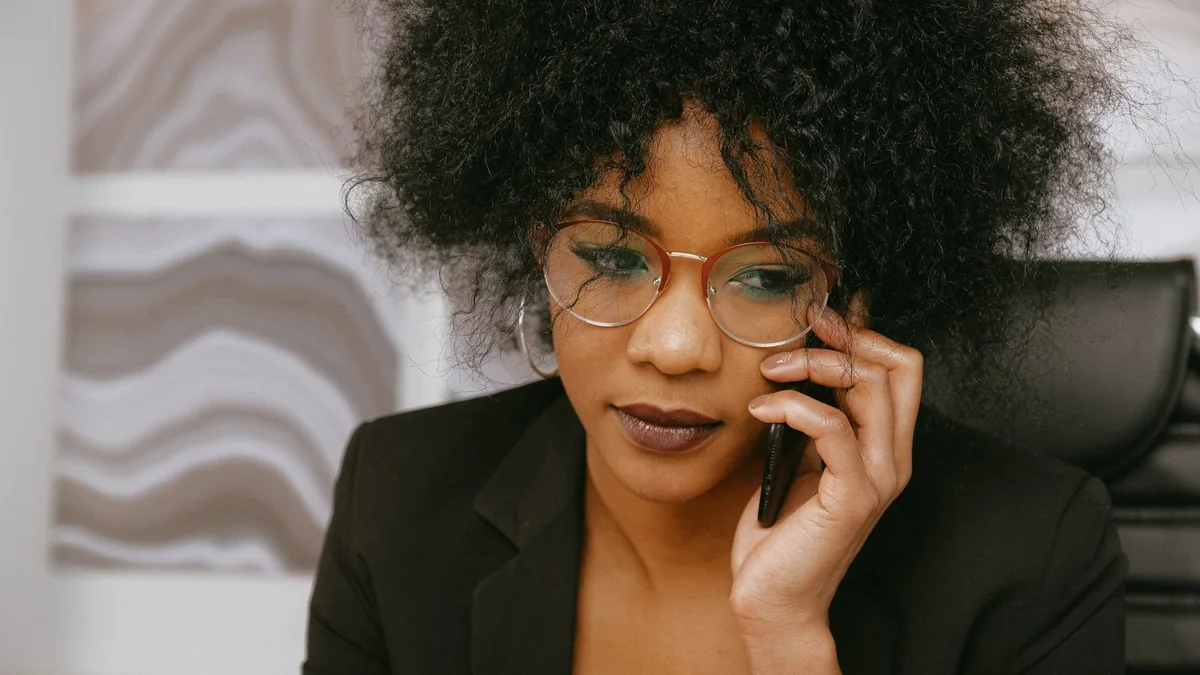A business owner on a phone call, from our GoHighLevel billing guide