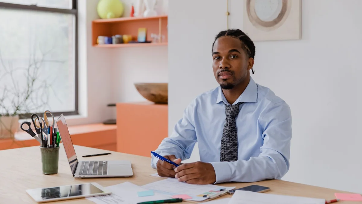 A business owner reviews figures at his desk, from our GoHighLevel dashboard guide