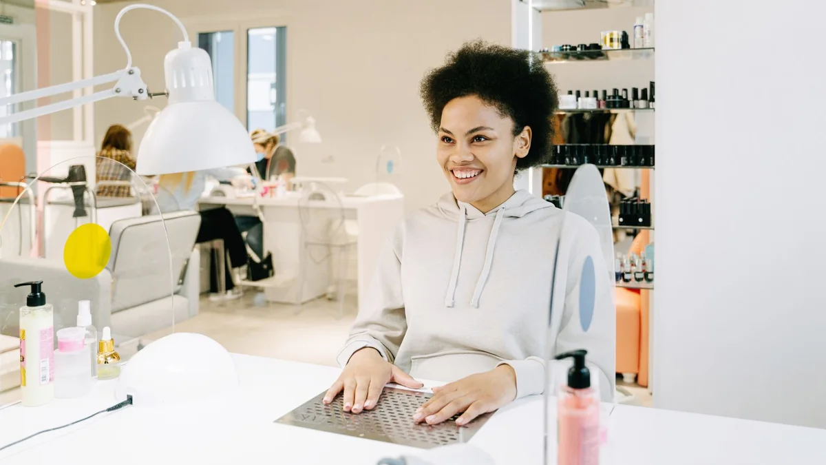 A salon owner at her front desk, from our GoHighLevel dashboard guide