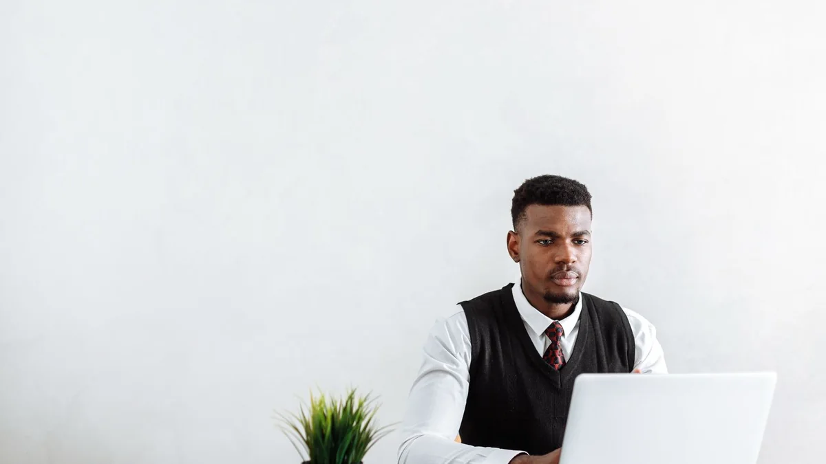 A business owner sets up his laptop at a clean desk, from our GoHighLevel pipeline guide